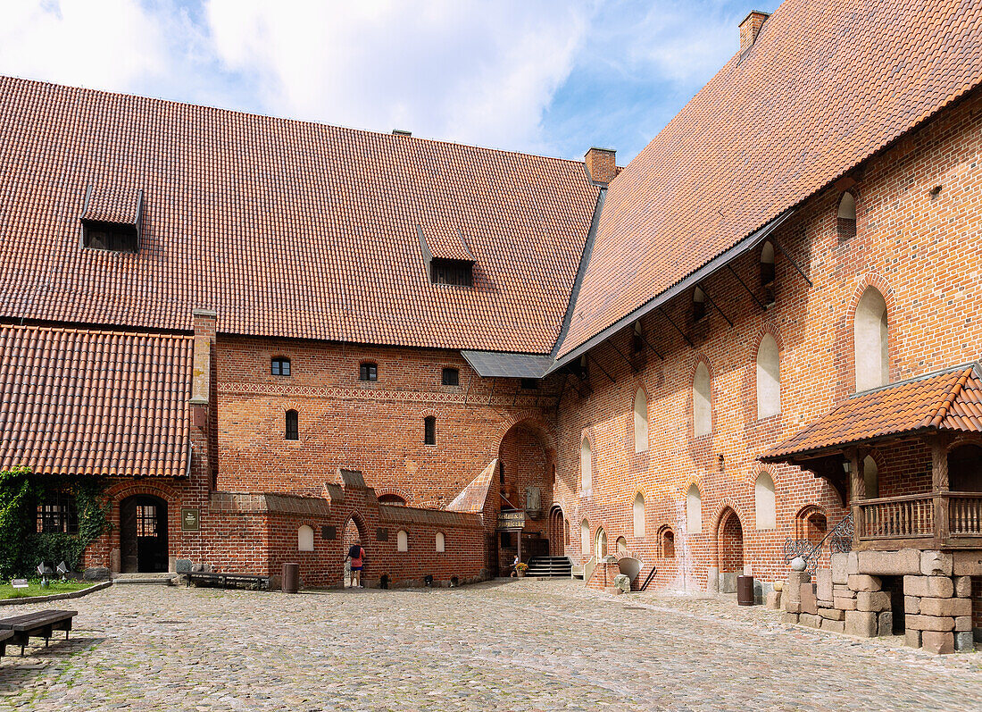 Inner courtyard of the central castle of the Marienburg (Zamek w Malborku) with a monumental figure of the Virgin Mary in Malbork in the Pomorskie Voivodeship in Poland