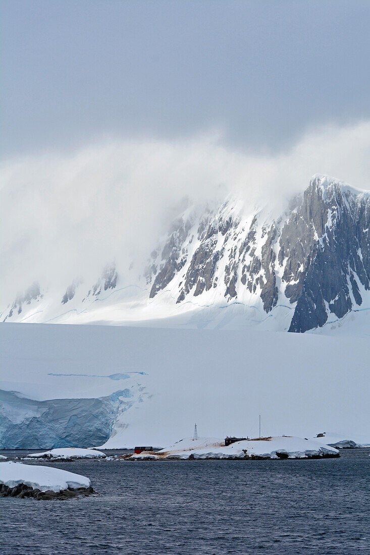 Antarctic; Antarctic Peninsula; Port Lockroy; British research station with post office; Snow covered mountains; Glacier with a cliff edge