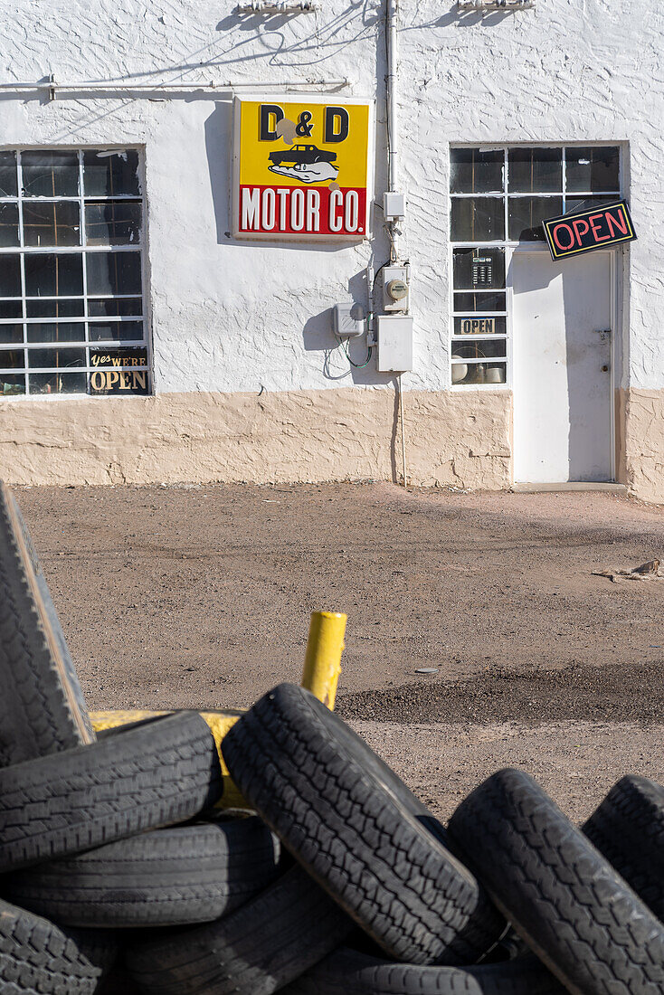 D and D Motor Co sign in Gallup New Mexico with sign announcing it is open.