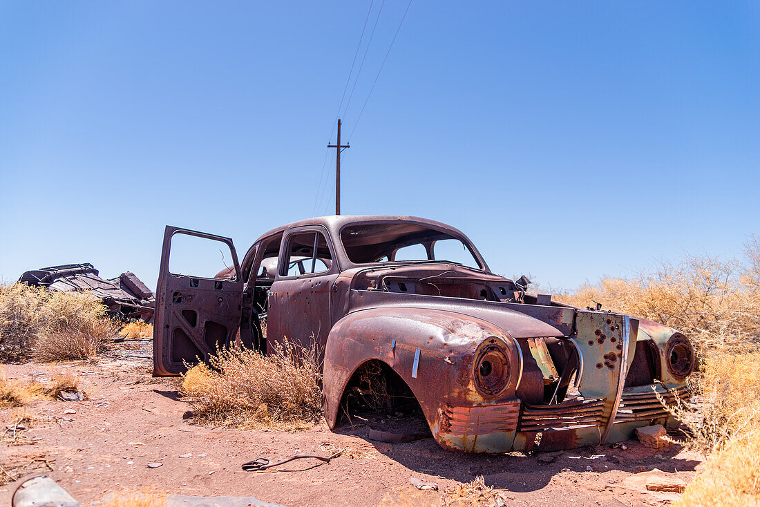 Rusted old car with bulletholes in the Arizona desert.