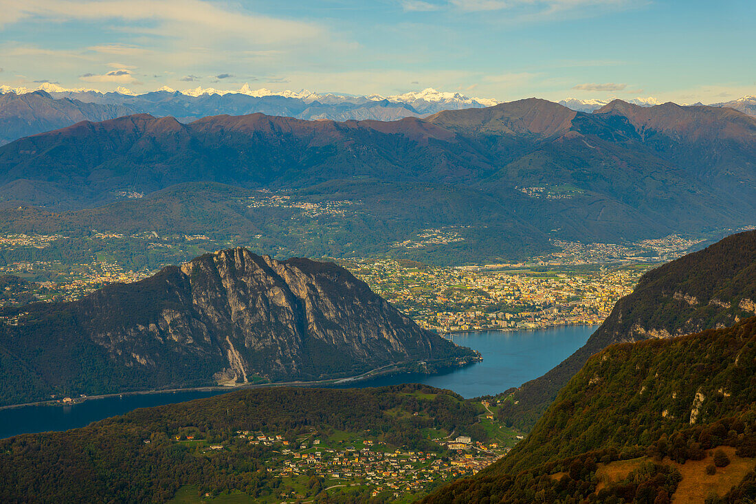 Aerial View over Beautiful Mountainscape with Snow Capped Mountain and Lake Lugano and City of Lugano in a Sunny Day From Monte Generoso, Ticino, Switzerland.