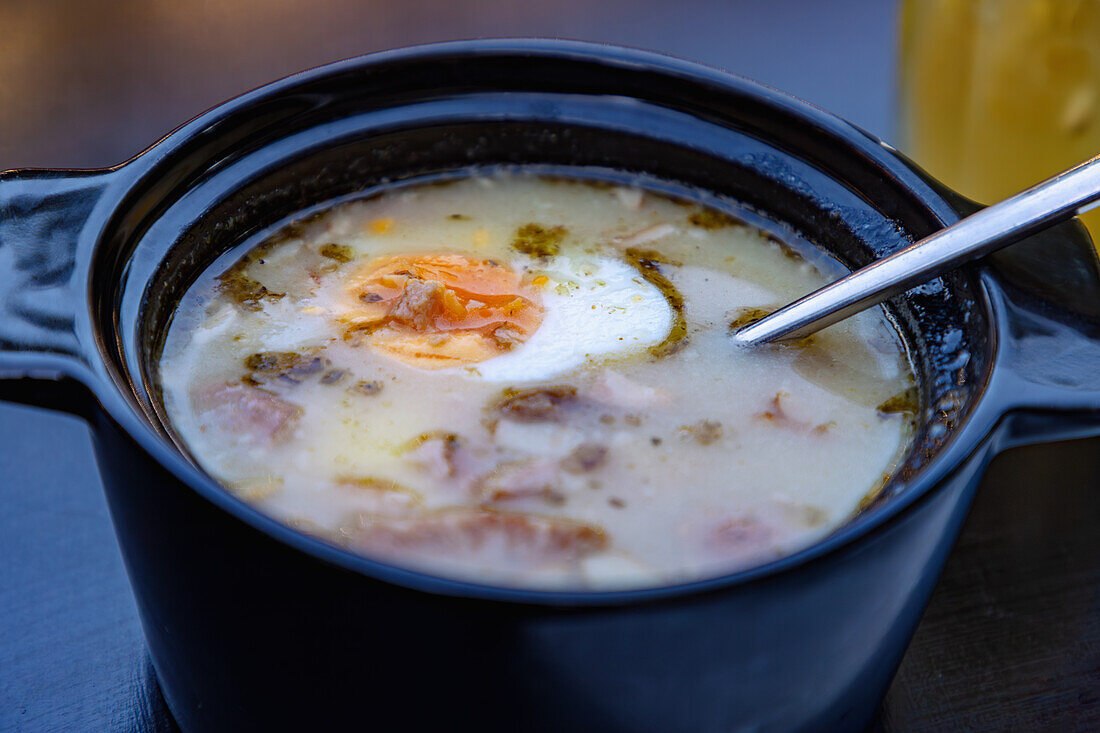 Polish sourdough soup with ham, sausage and egg (Żurek na Zakwasie) served in Karpacz (Krummhübel) in the Giant Mountains (Krkonoše National Park; Karkonoski Park Narodowy) in the Dolnośląskie Voivodeship of Poland