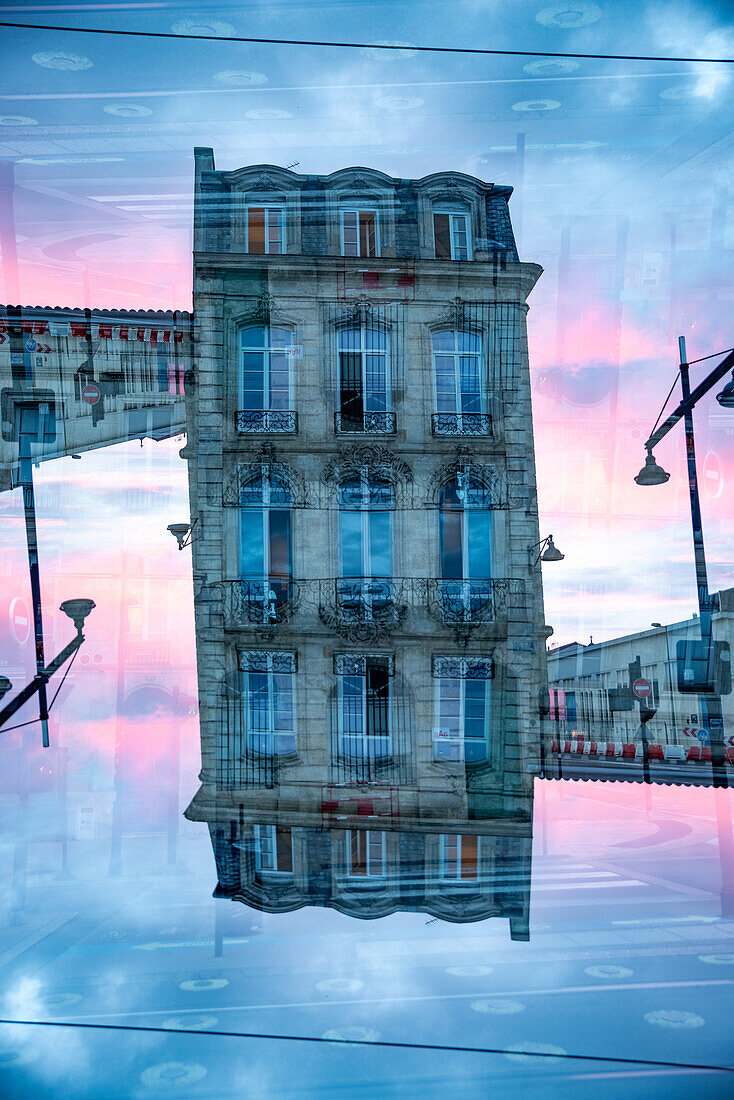 Double exposure of a residential building in colourful evening light in bordeaux, France.