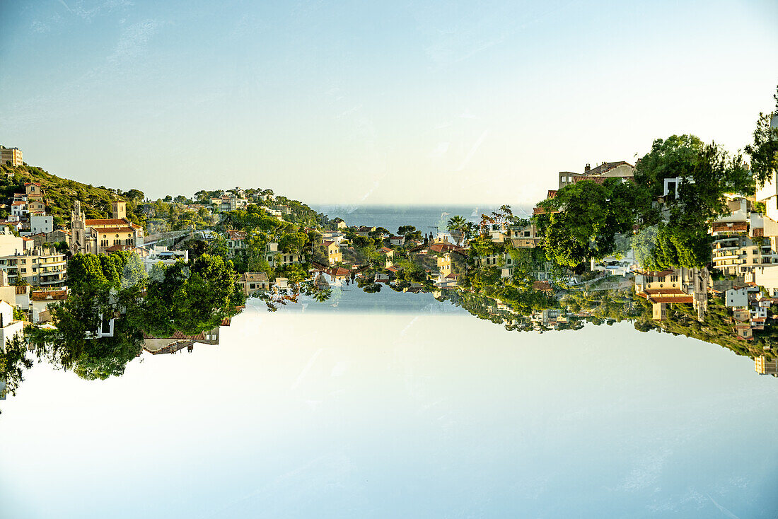 Double exposure of residential buildings on a hillside and the Mediterranean sea in Marseille , France.