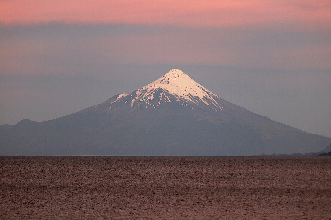 Chile; Southern Chile; Los Lagos Region; Mountains of the southern Cordillera Patagonica; Sunset over the Osorno volcano; in the foreground Lake Llanguihue