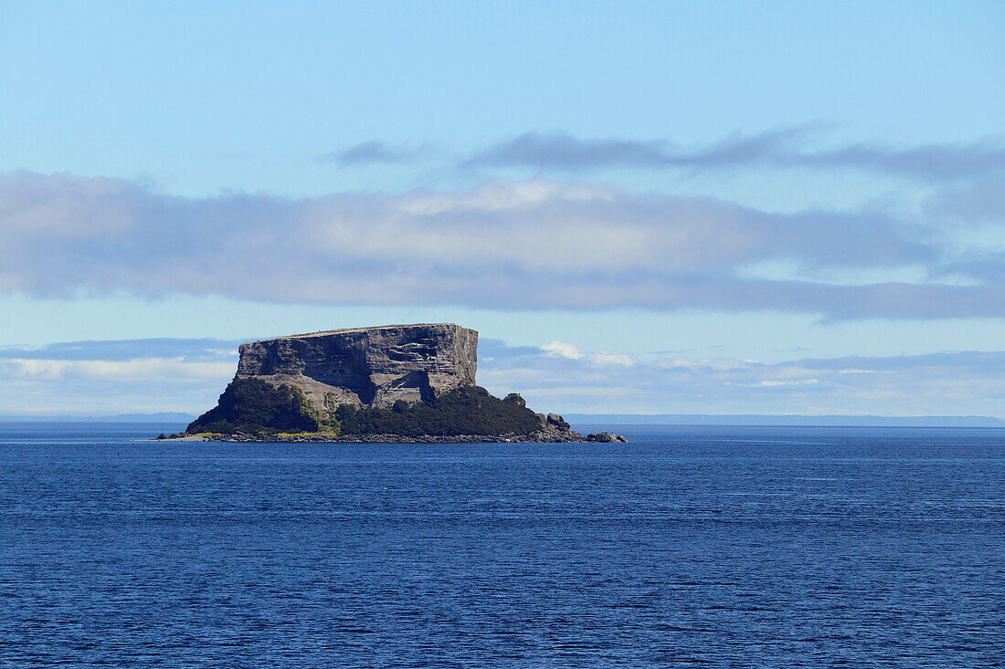 Chile; Southern Chile; Los Lagos Region; Mountains of the southern Cordillera Patagonica; on the Navimag ferry through the Patagonian fjords; Golfo de Ancud; small rock island Nihue