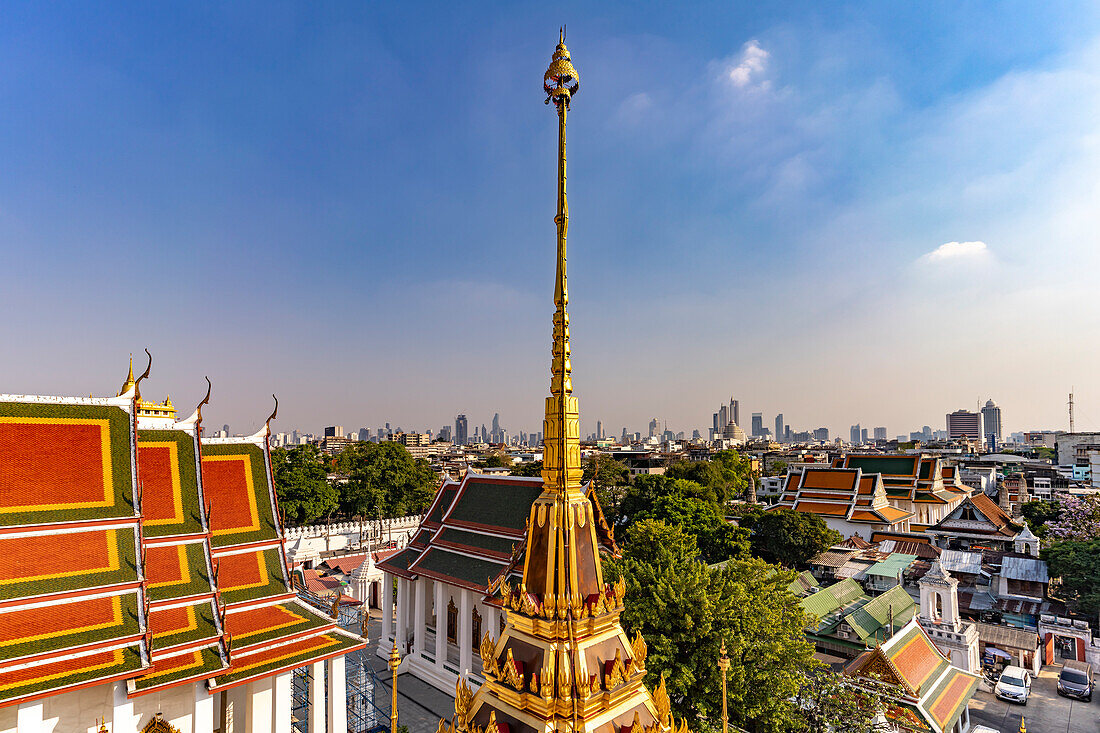the Buddhist temple complex Wat Ratchanatdaram and the skyline of Bangkok, Thailand, Asia