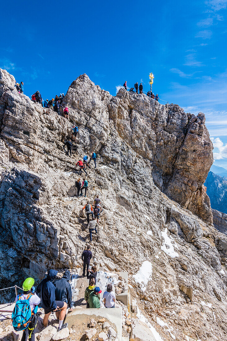 Climbers, summit cross, Zugspitze, Partenkirchen, Bavaria, Germany