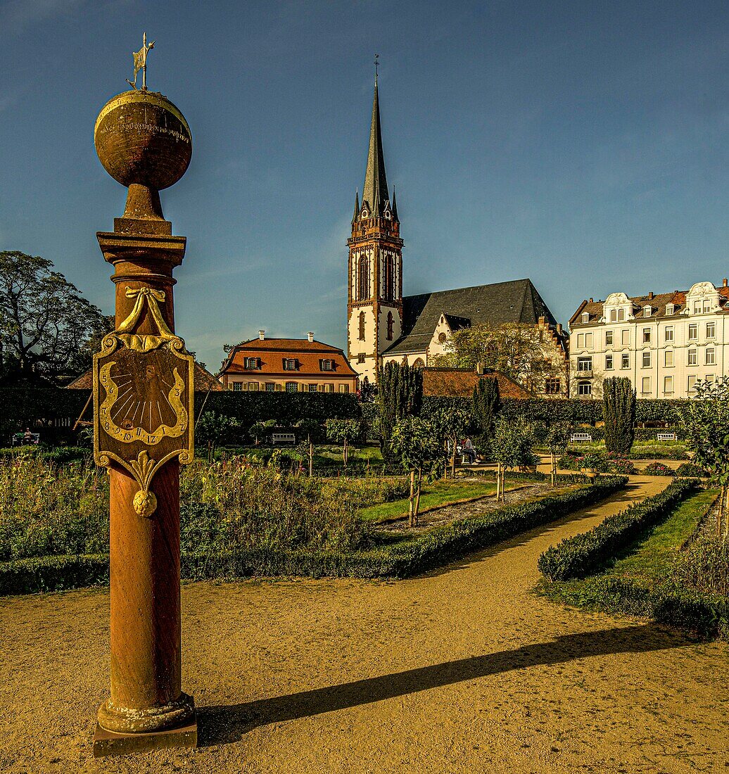 Sundial in the Prinz-Georg-Garten, in the background the Prinz-Georg-Palais and the Church of St. Elisabeth, Darmstadt, Hesse, Germany