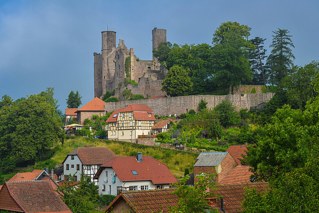 View over the roofs of Rimbach to the ruins of Hanstein Castle, Thuringia, Germany