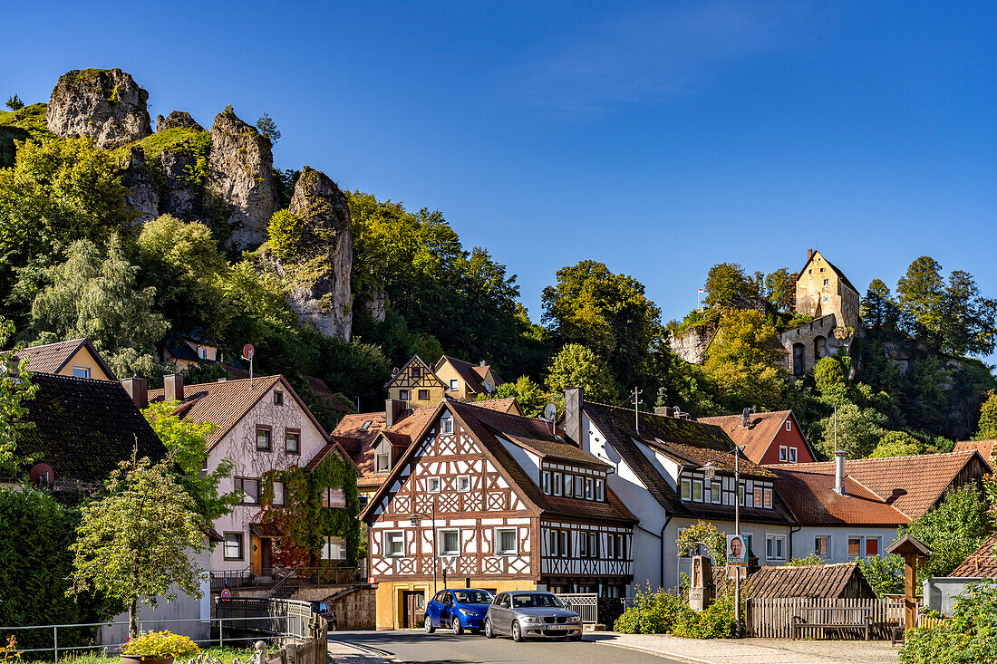  Half-timbered structure and castle in Pottenstein in Franconian Switzerland, Bavaria, Germany  