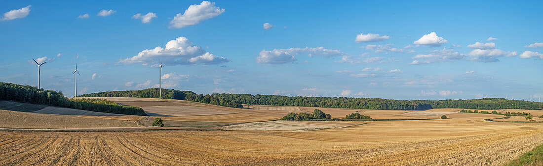  harvested fields with wind turbines in the Main-Tauber district near Wertheim, Baden Württemberg, Germany 