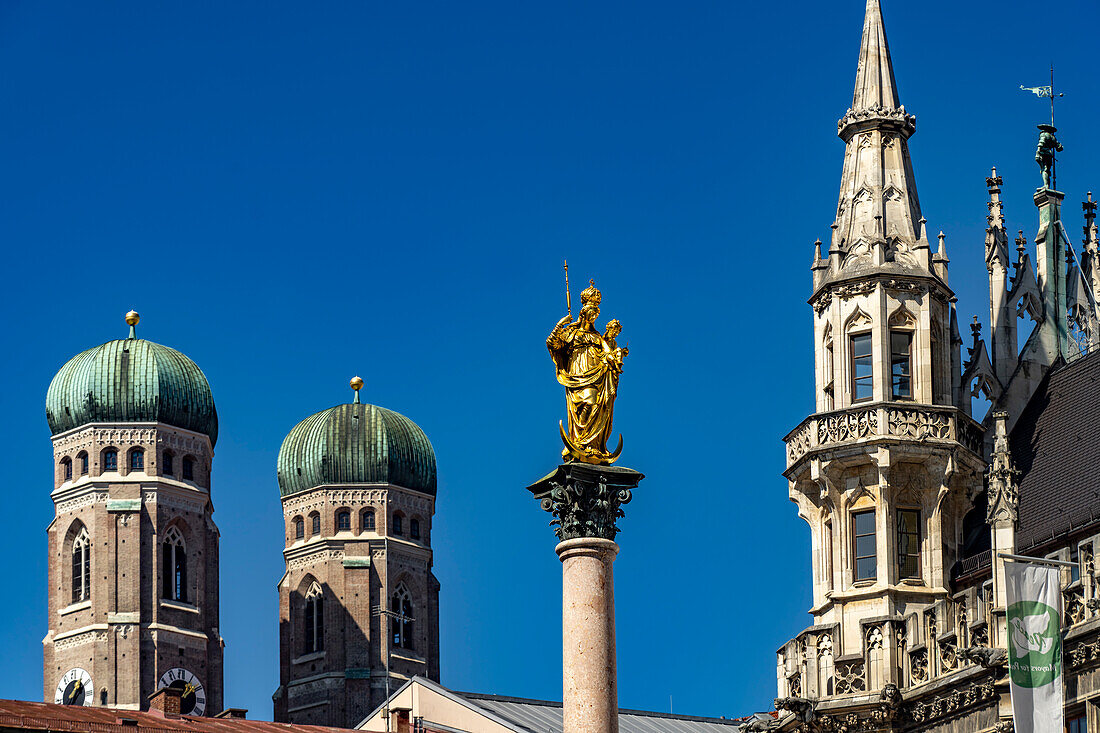  Statue of Mary on the Marian Column and the towers of the Frauenkirche and New Town Hall in Munich, Bavaria, Germany   