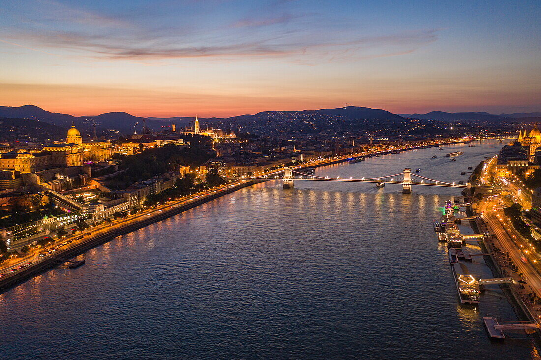 Aerial view of Danube with Széchenyi Chain Bridge, Buda Castle and Fisherman's Bastion at dusk, Budapest, Pest, Hungary, Europe