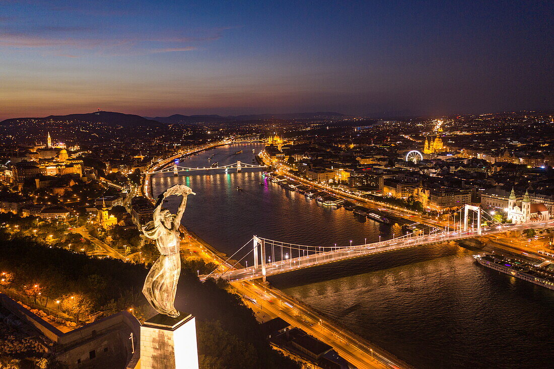 Aerial view of Gellert Hill and Citadel with Statue of Liberty and Danube at night, Budapest, Pest, Hungary, Europe