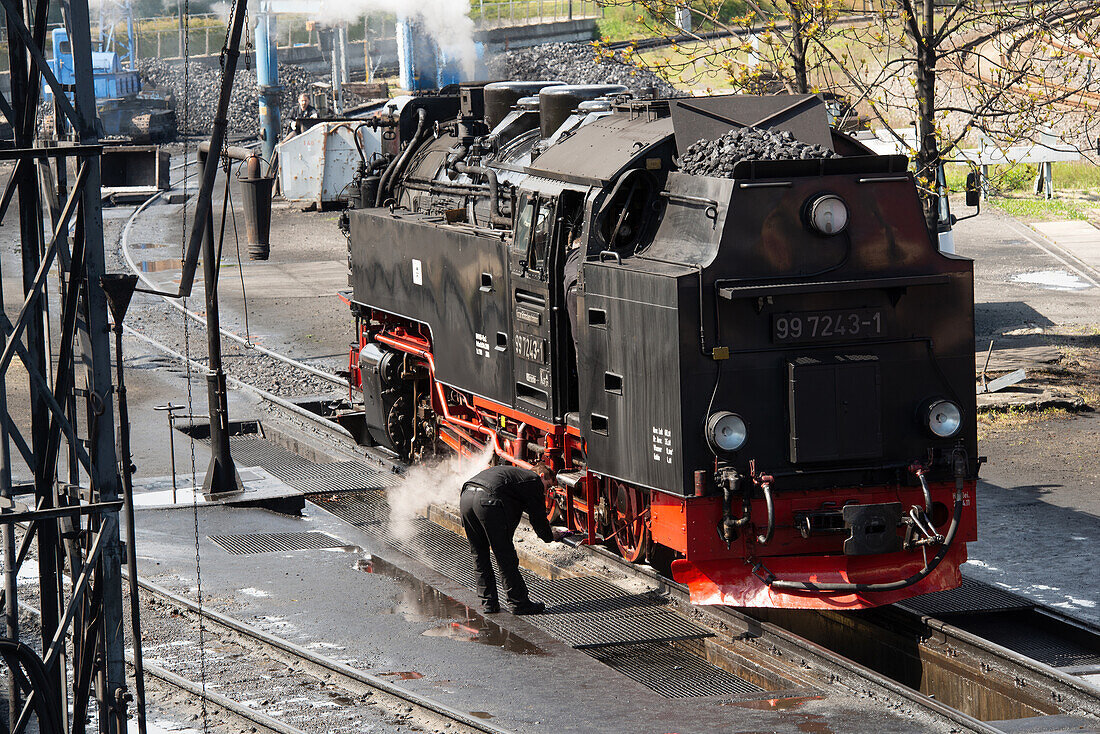 Harz narrow-gauge railways; Maintenance of a class 99 steam locomotive in the train station of Werningerode, Saxony-Anhalt, Germany_