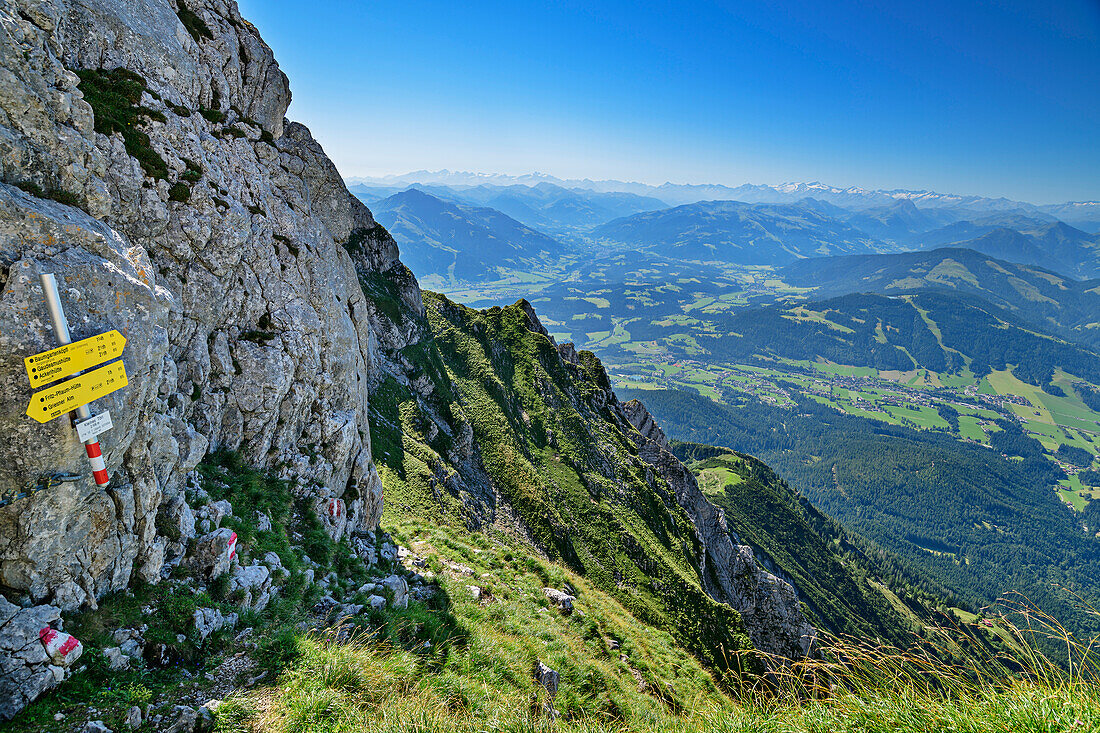 Signpost at Kleiner Törl, Kitzbühel Alps and Hohe Tauern in the background, from Kleiner Törl, Kaisergebirge, Tyrol, Austria