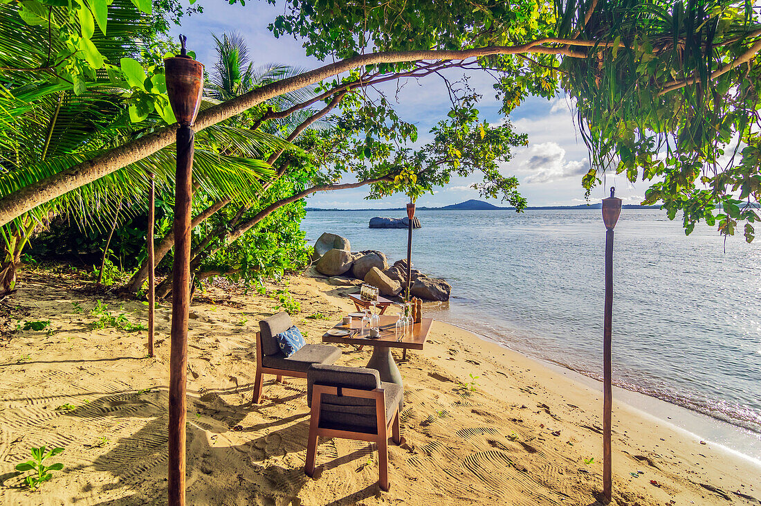 Einsamer Strand mit Sitzplatz auf einer Insel in der Nähe von Bintan, Riau-Archipel, Indonesien, Südostasien