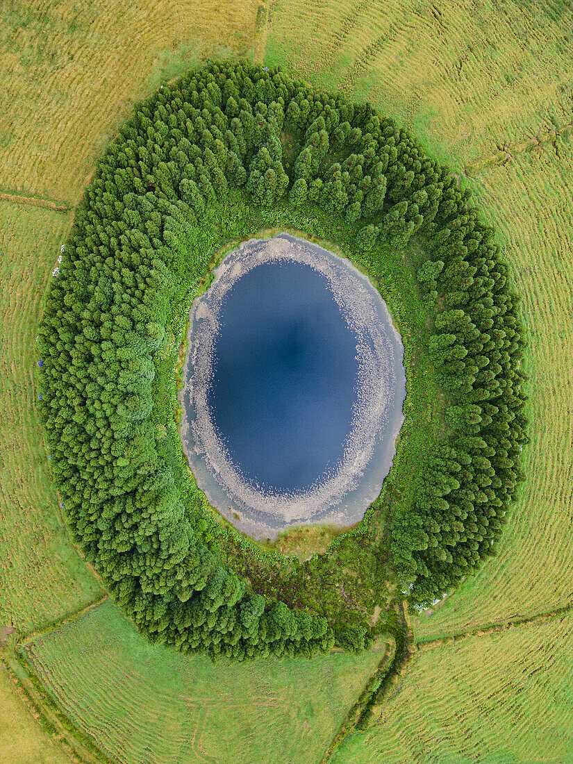  Aerial view of the small volcanic lake Lagoa do Pau Pique on Sao Miguel, Azores. 