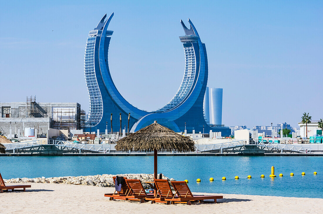  Beach in the area of The Pearl, in the background the Raffles Hotel, in Doha, capital of Qatar in the Persian Gulf. 