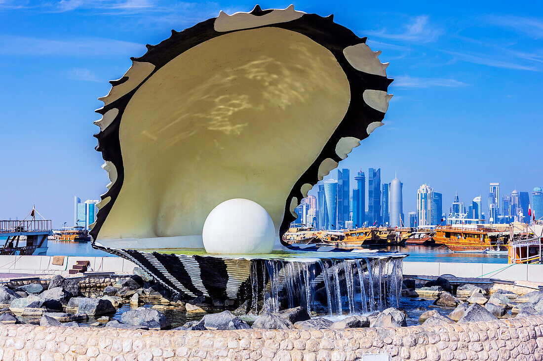  Pearl Fountain. Harbor views with skyscrapers and ships in Doha, capital of Qatar in the Persian Gulf. 