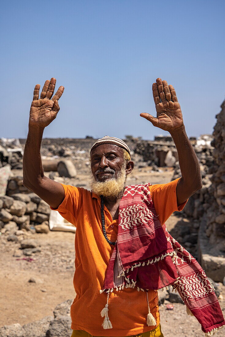  Friendly elderly man with arms raised in village, near Arta, Djibouti, Middle East 