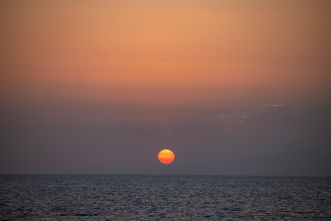  Sunset in the Bab-el-Mandeb Strait between the Arabian Peninsula and Djibouti, at sea, near Yemen, Middle East 