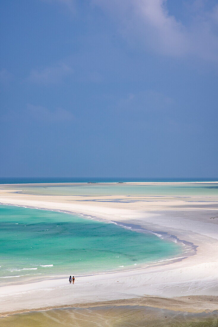  Two women stroll along Qalansiyah Beach, Qalansiyah, Socotra Island, Yemen, Middle East 