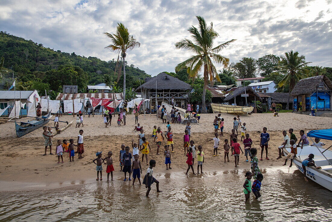  Group of cheering children say goodbye to visitors, Nosy Komba, Diana, Madagascar, Indian Ocean 