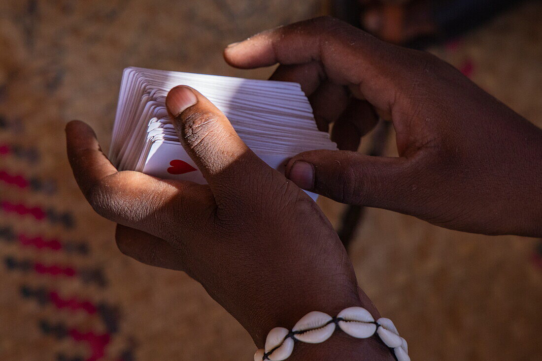  Detailed view of playing cards in hands with visible suit of hearts, Mahajanga, Boeny, Madagascar, Indian Ocean 