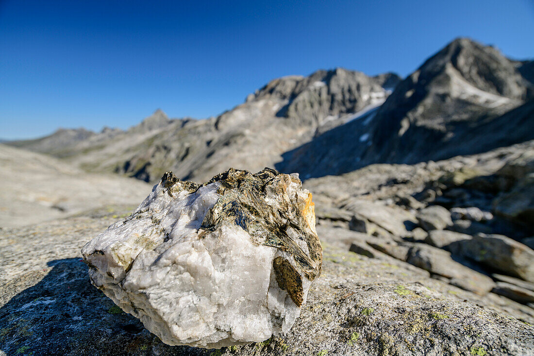  Quartz stone with Zillertal Alps out of focus in the background, from Keilbachjoch, Zillertal Alps, Zillertal Alps Nature Park, Tyrol, Austria 