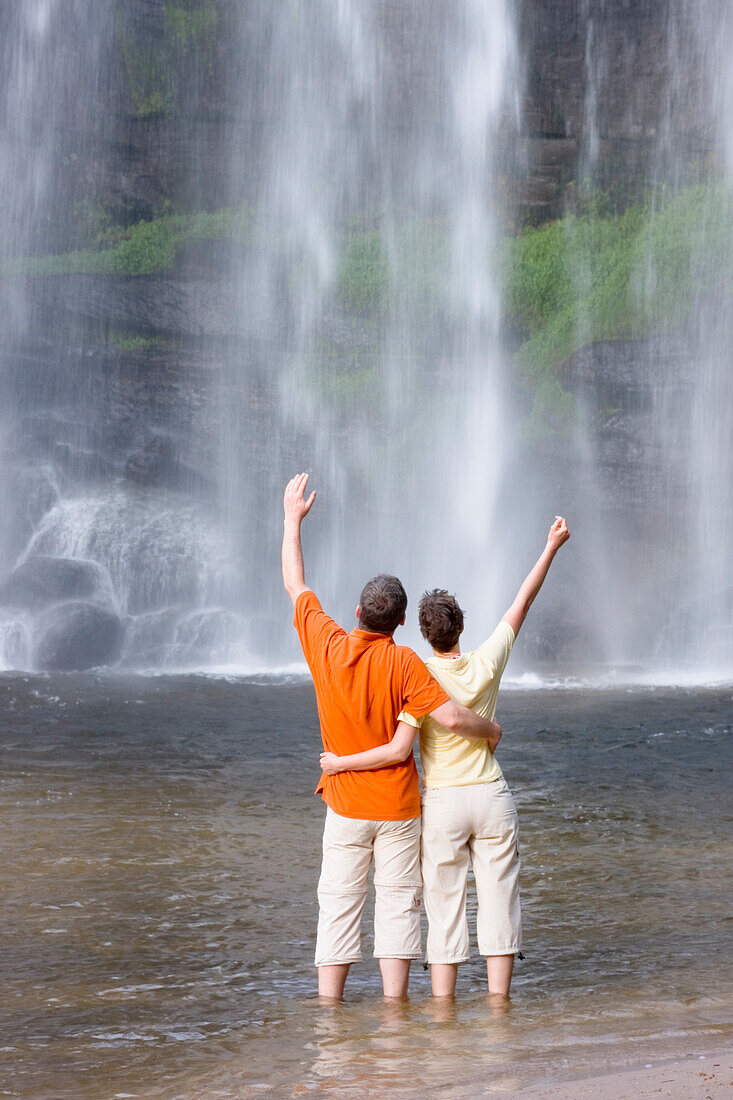  A couple enjoys a waterfall in Ponta Grossa, Paraná, Brazil 