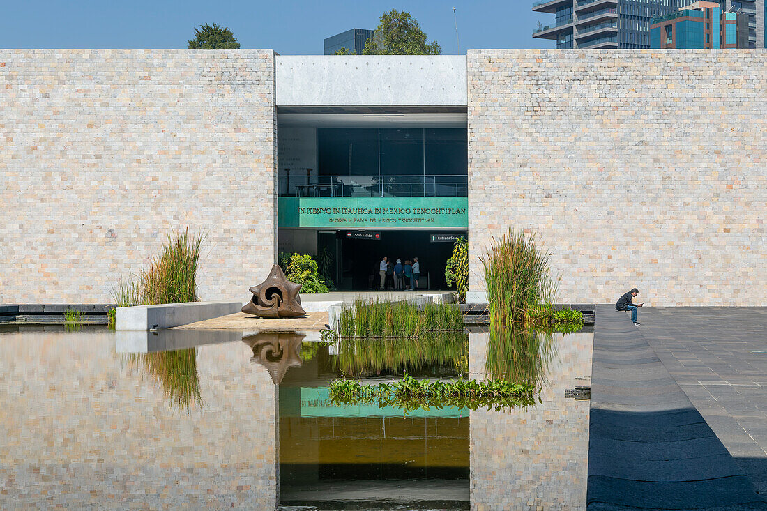 Entrance of Tenochtitlan gallery reflected in water, courtyard National Anthropology Museum, Mexico City, Mexico
