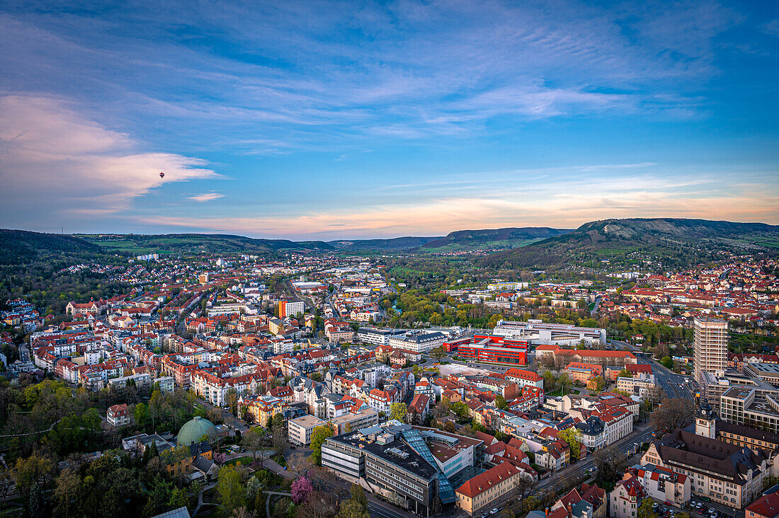 Blick über die Stadt Jena, Kernberge im Hintergrund bei Sonnenuntergang und blauem Himmel, Jena, Thüringen, Deutschland