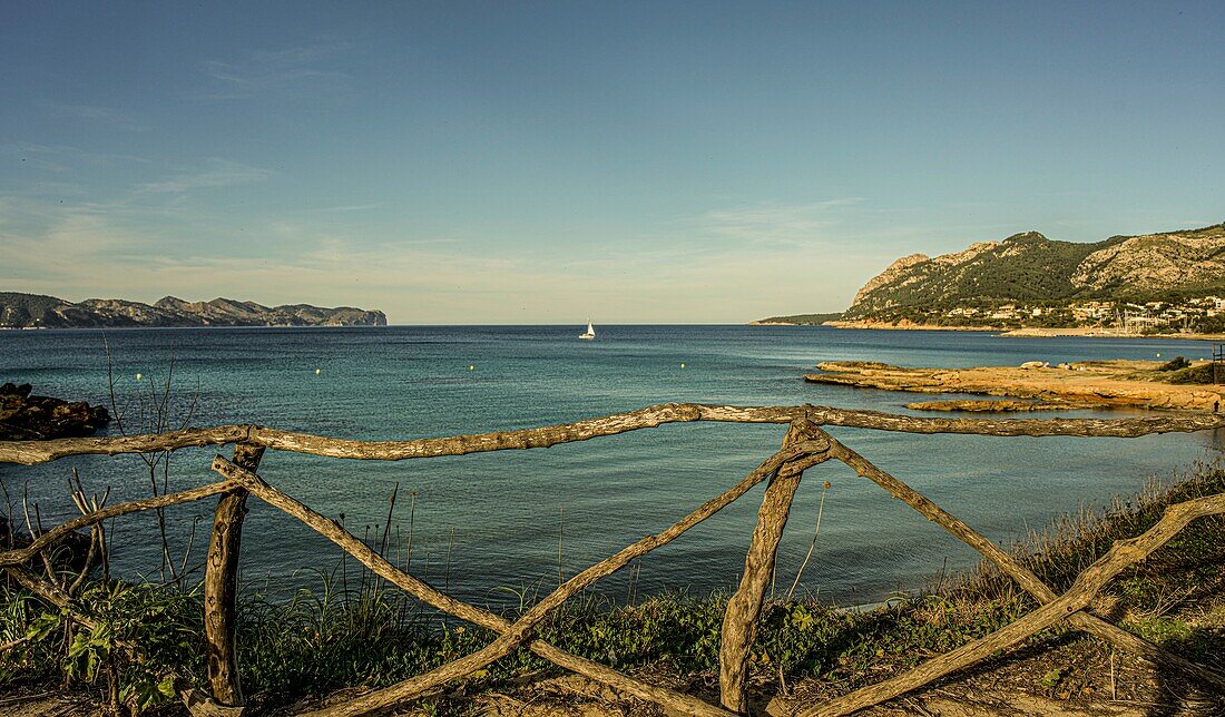 Blick auf die Bucht bei der Platja de Sant Joan, Segelboot im Hintergrund, Alcudia, Mallorca, Spanien