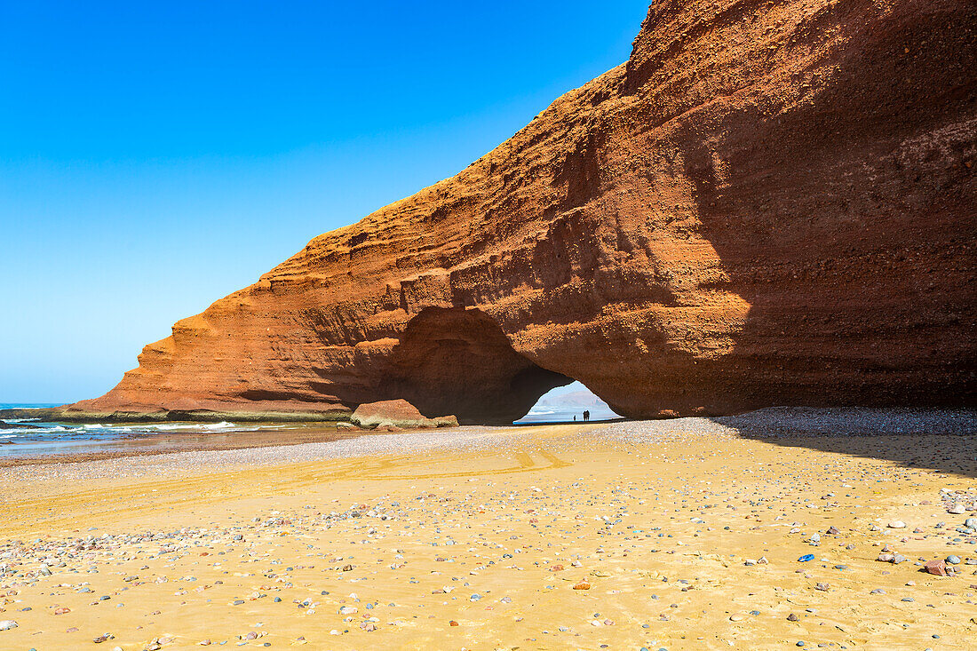 Natural rock coastal arch erosional landform on beach, Legzira, southern Morocco, north Africa