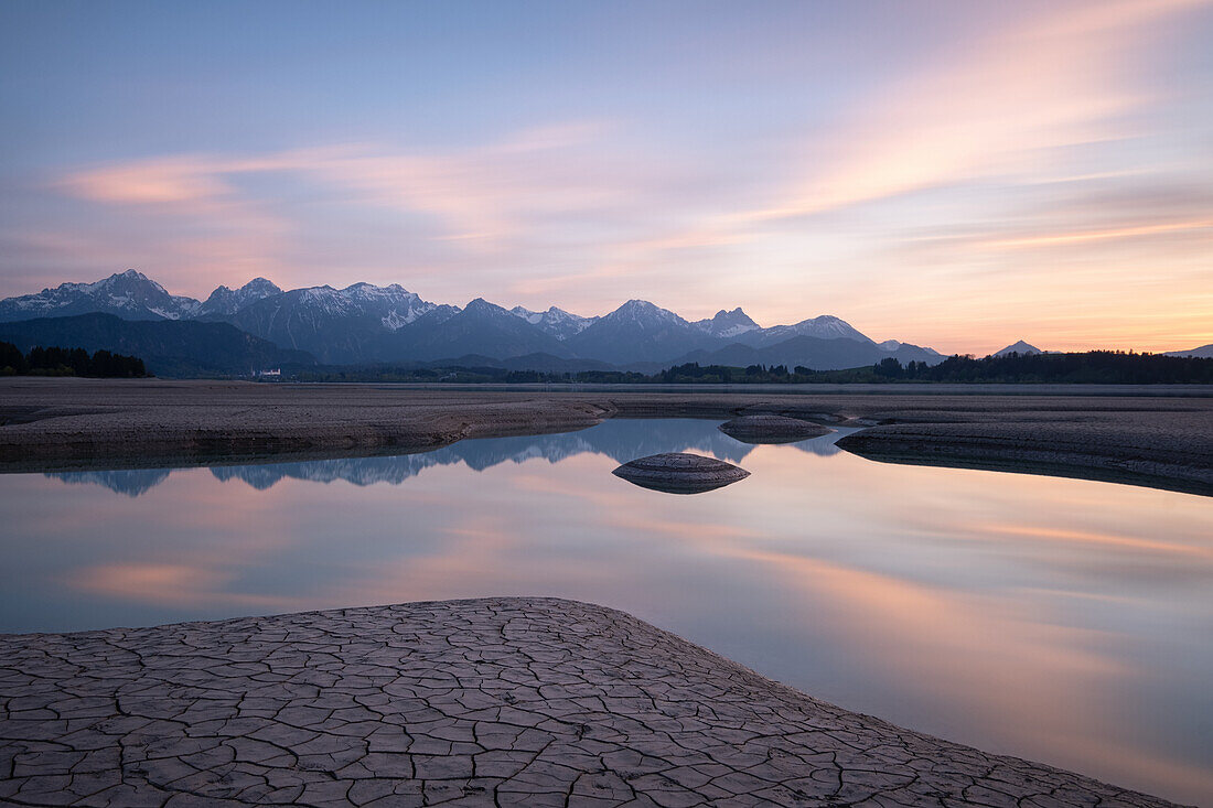  Pool of water in the dry Forggensee at sunset, Bavaria, Germany, Europe 