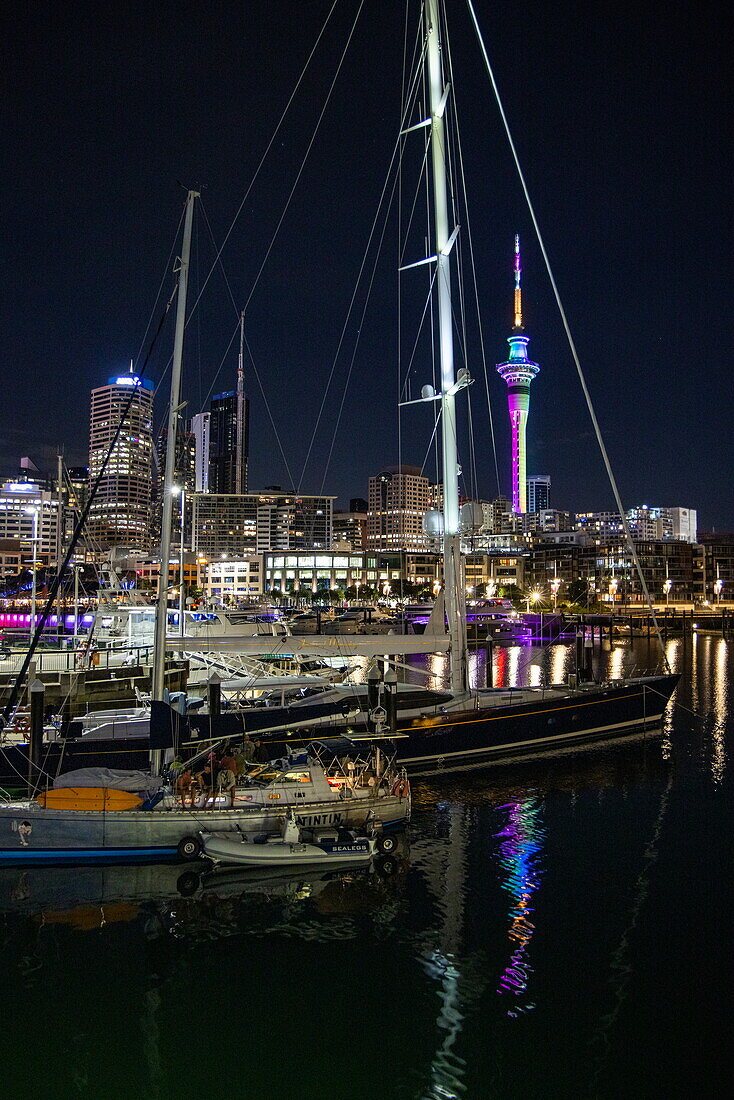  Boats in Viaduct Basin with bars and illuminated Sky Tower at night, Auckland, North Island, New Zealand 