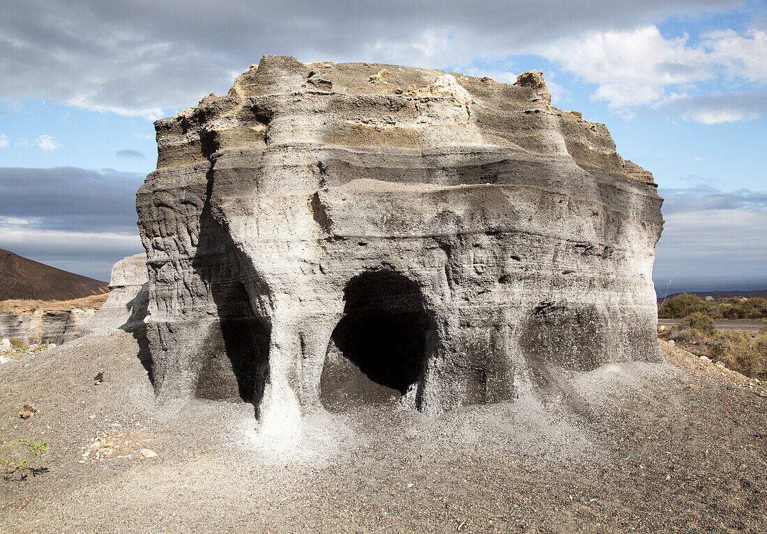 Layers of black volcanic ash quarried by humans and eroded by nature, Lanzarote, Canary islands, Spain