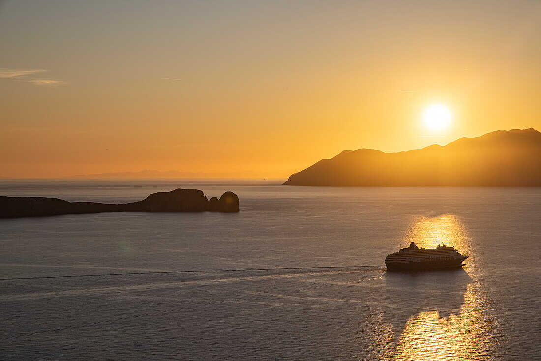  Silhouette of cruise ship Celestyal Journey (Celestyal Cruises) and islands at sunset, Plaka, Milos, South Aegean, Greece, Europe 