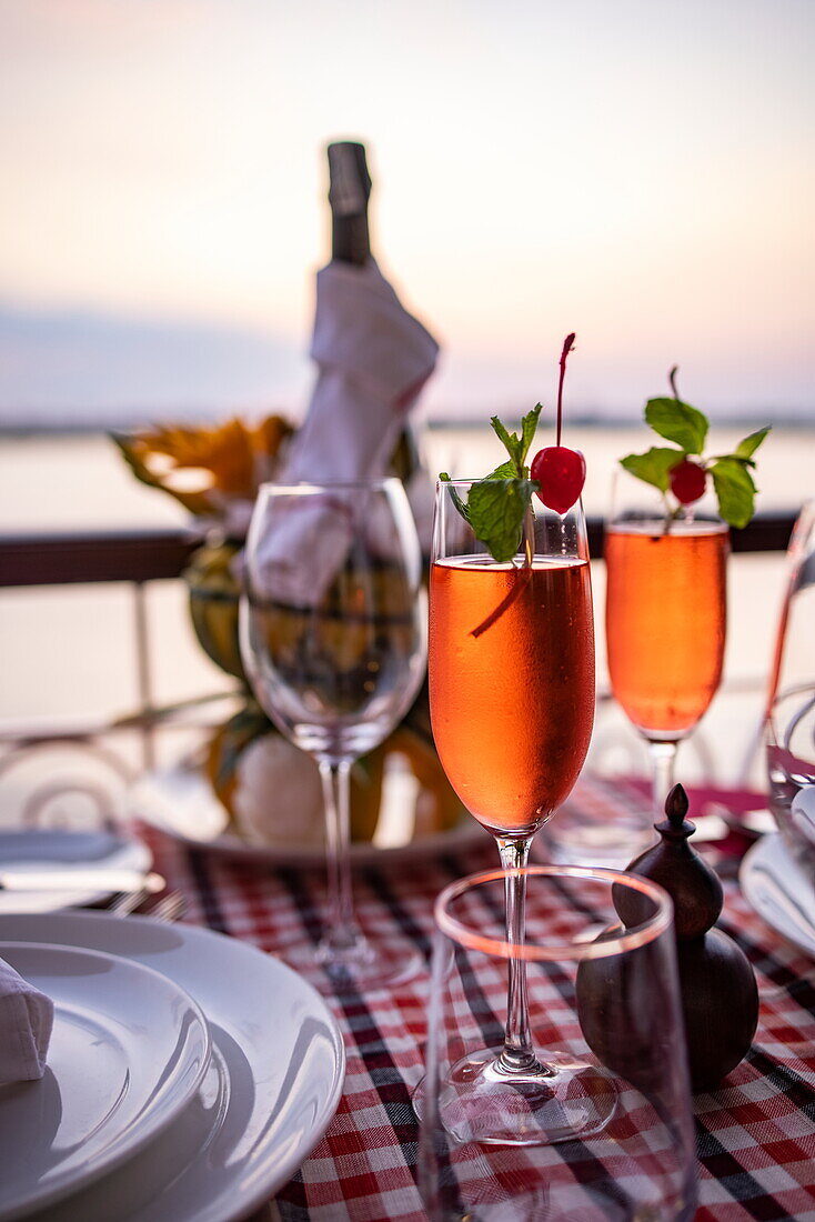  Detail of champagne glasses during a private dinner on the balcony of a deluxe cabin on board the river cruise ship The Jahan (Heritage Line) on the Mekong River, near Cao Lanh (Cao Lãnh), Dong Thap (Đồng Tháp), Vietnam, Asia 