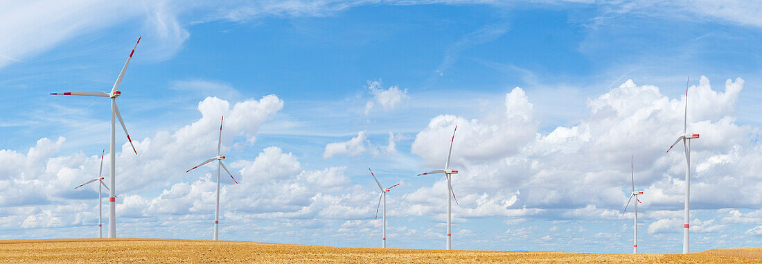  Wind turbines against a blue cloudy sky, Alzey, Rhineland-Palatinate, Germany 