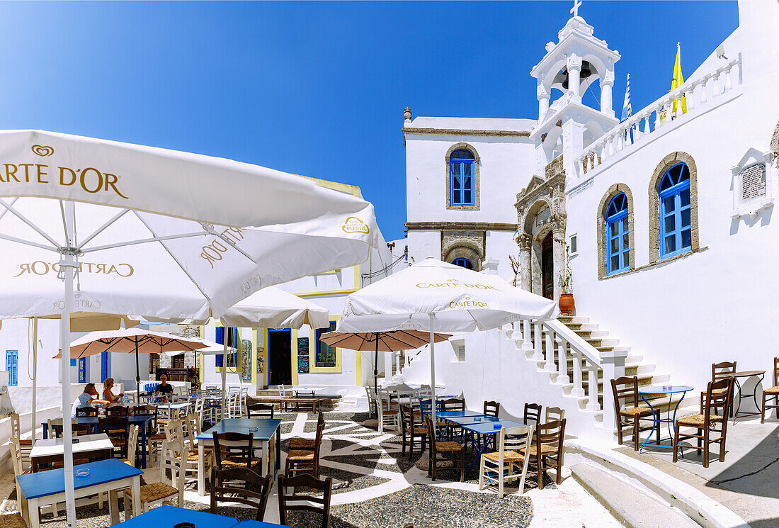  Village square with pebble mosaics, cafe and Church of the Assumption of the Virgin Mary in the mountain village of Nikiá on the island of Nissyros (Nisyros, Nissiros, Nisiros) in Greece 