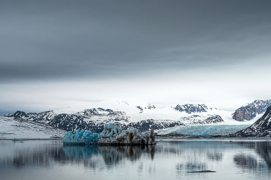  View of snow-capped mountains and an iceberg in the Isfjord, Spitsbergen, Svalbard, Norway, Arctic 