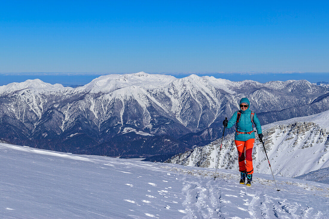  Woman on ski tour ascends to Pyhrner Kampl, Totes Gebirge, Upper Austria, Austria 