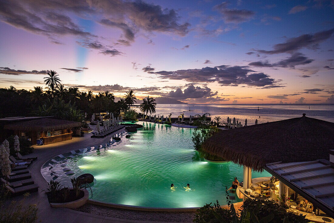  Illuminated pool of the Hilton Hotel Tahiti at dusk, Tahiti, Windward Islands, French Polynesia, South Pacific 