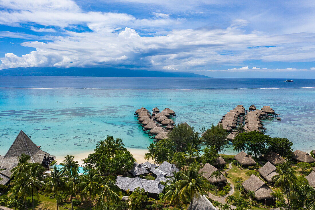  Aerial view of Sofitel Ia Ora Beach Resort with overwater bungalows and view of Tahiti, Moorea, Windward Islands, French Polynesia, South Pacific 