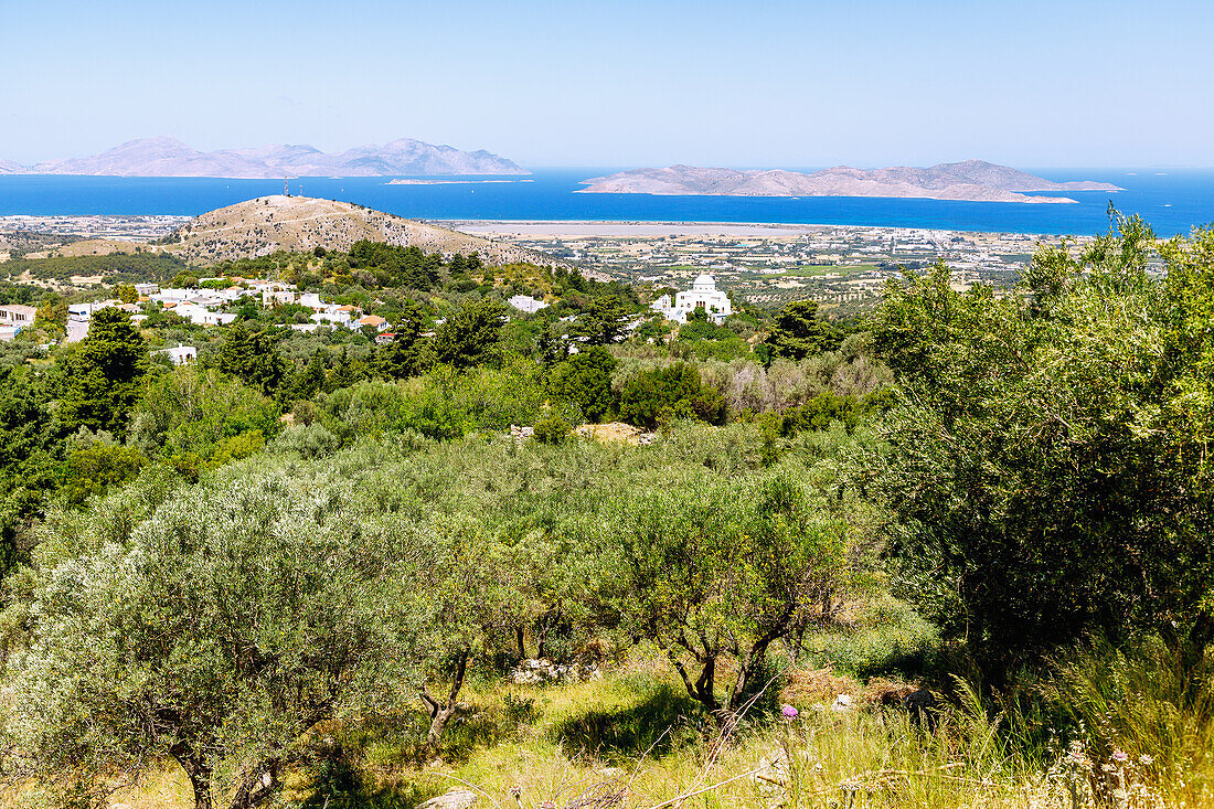  View from the mountain village of Zia to the mountain village of Lagoudi with the church of Panagia Theotokou Genesiou (Kimissis tis Theotokou) and the salt lake Alikes on the island of Kos and to the islands of Kalymnos and Pserimos in Greece 