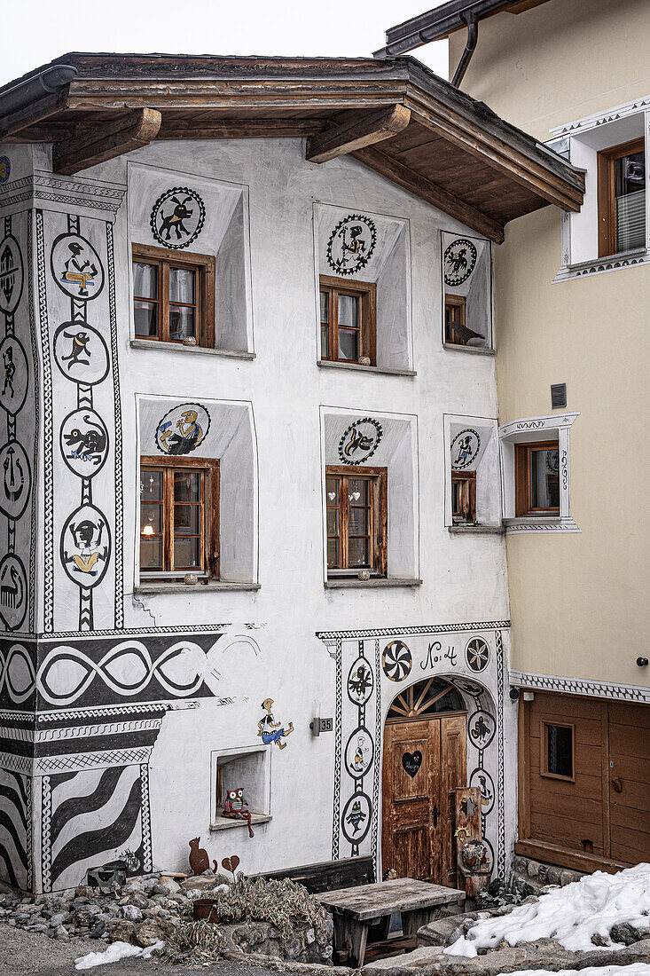  Traditional house with sgraffiti on facade, in ValcaHva, Graubünden, Switzerland 