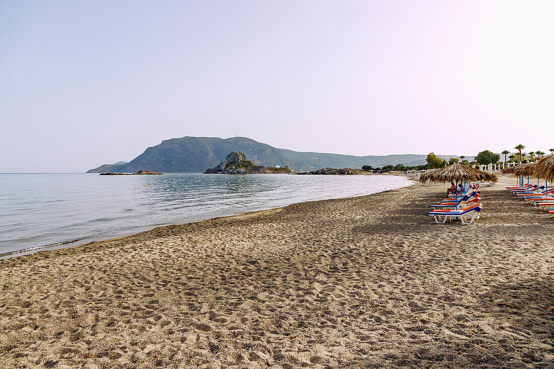  Agios Stefanos Beach overlooking the island of Kastri with the chapel of Agios Nikolaos and the bay of Kefalos on the island of Kos in Greece  